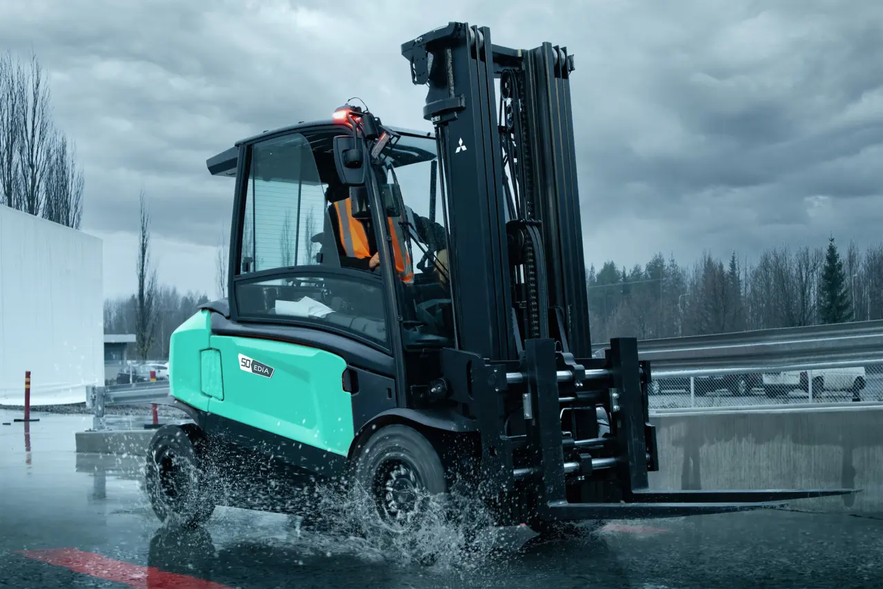 EDiA 50-gaffeltruck fra Logisnext Denmark kører gennem regnvejr på udendørs areal